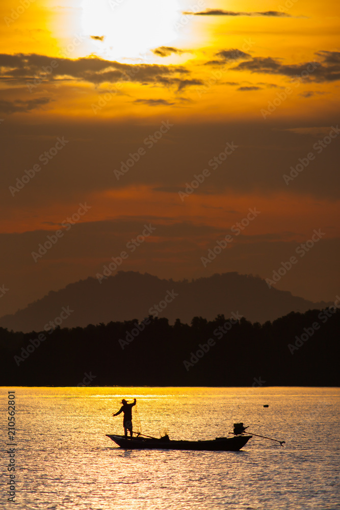 Landscape view of sunset with boat is floating on water reflection from sun