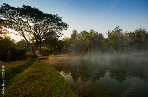 A natural fountain of clear water in morning time with cloudy foggy located in front of mountain at north of Thailand. Concept of healthy place 
