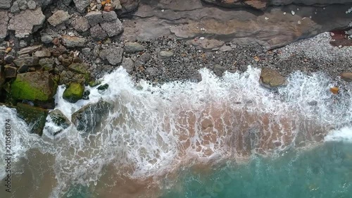 Wallpaper Mural Aerial top view of sea waves hitting rocks on the beach with turquoise sea water. Amazing rock cliff seascape in the Portuguese coastline. Torontodigital.ca