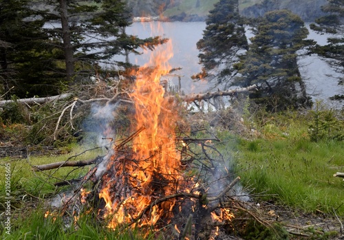 closeup of a bonfire on a hill overlooking the bay, Newfoundland Canada 