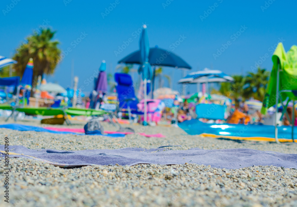 Close-up of a beach tablecloth lying on the beach. Background all out of focus