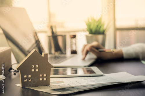 Hand of Business people calculating interest, taxes and profits to invest in real estate and home buying