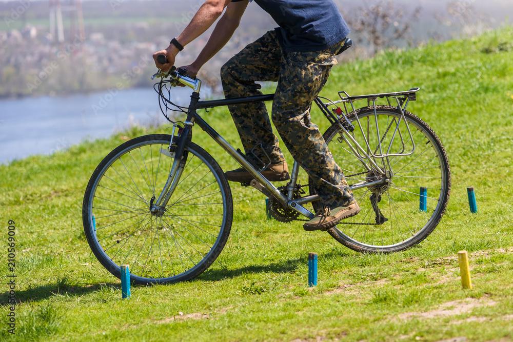 Fototapeta premium photo of man training in bicycle riding with obstacles