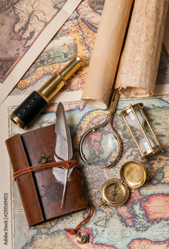 Planning a trip: quill pen, old papers and maps with vintage items
