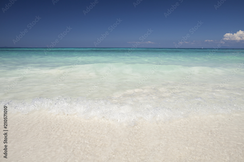 White sand beautiful beach at tropicana under clear sky and mountain located south of Thailand