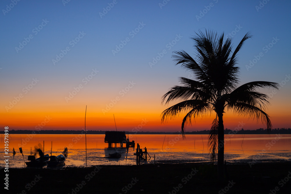 A colorful of sunset timing with palm tree at twilight time located at tropicana north east of Thailand
