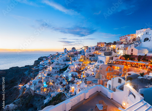 Colorful dramatic light at sunset and the picturesque Oia village, Santorini, Greece. Incredibly romantic sunset on Santorini. Amazing sunset view with white houses.