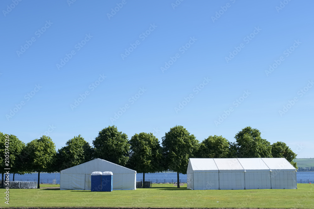 Festival white tents marquee park summer blue sky uk Festival white tents marquee park summer blue sky uk