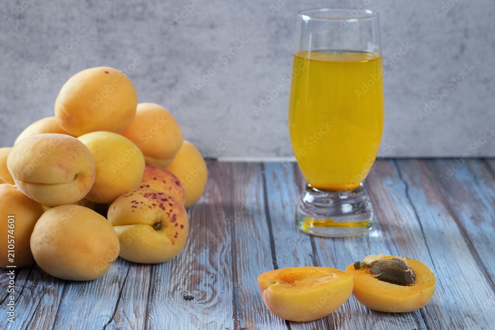 Group of juicy apricots and glass of fresh juice is an old light blue top. Group of juicy apricots and glass of fresh juice is an old light blue top.