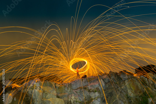burning steel wool on the mountain rock above lagoon