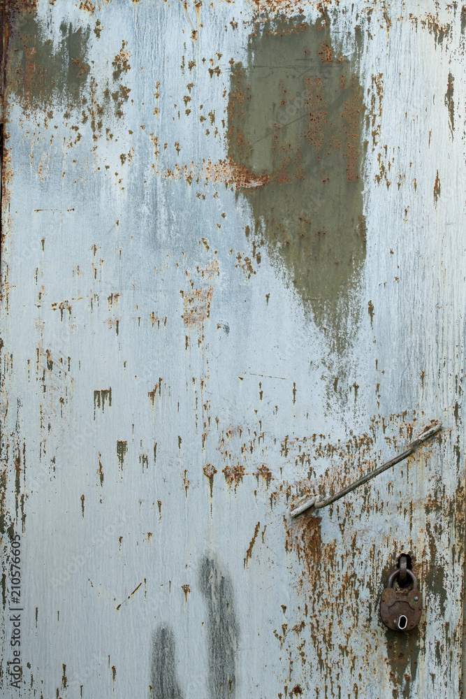 The Texture Of A Rusty Iron Door With A Lock And A Handle. The Texture Of A Rusty Iron Door With A Lock And A Handle.