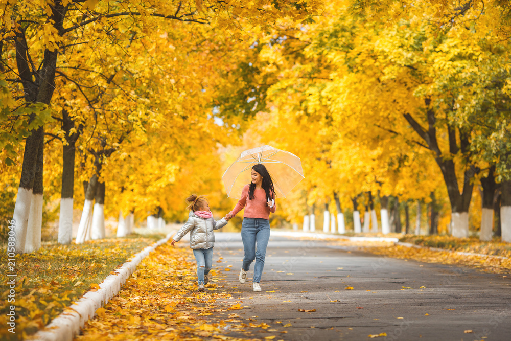 Cheerful girls walking the autumn park togrther Cheerful girls walking the autumn park togrther