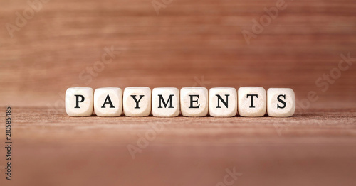 Word PAYMENTS made with wood building blocks