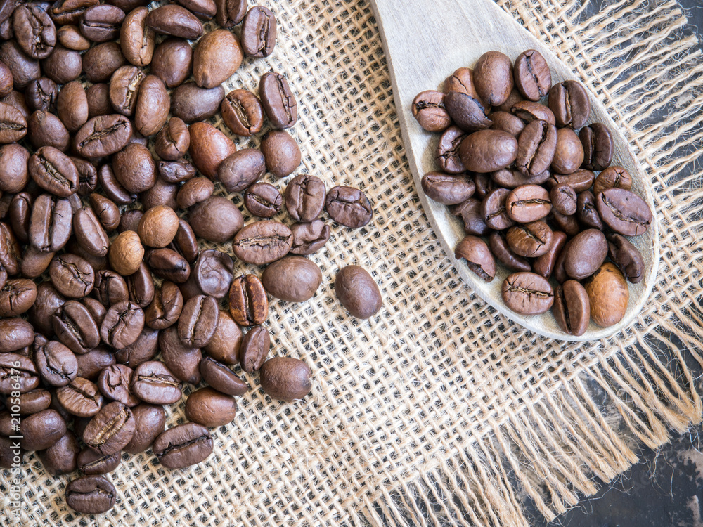 coffee beans background with wooden spoon coffee beans background with wooden spoon