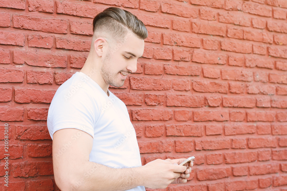 Latin man typing on his phone. Latin man typing on his phone.