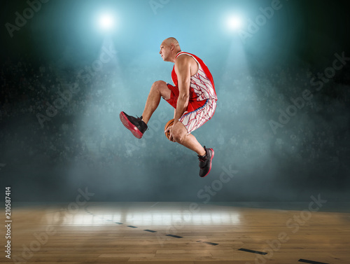 Caucasian Basketball Player in dynamic action with ball  © Andrii IURLOV