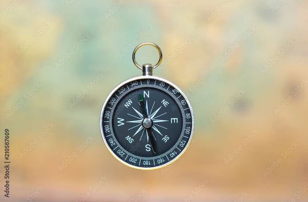 compass on a blurred background of an old map