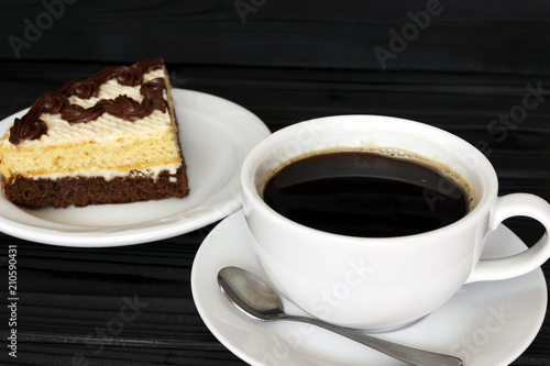 coffee with foam and cake on a dark background