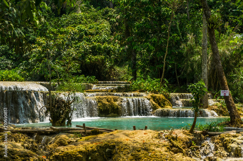 Tad Kwang Si  Xi  the biggest water fall land mark in Luang Prabang  Laos  beautiful turquoise color water at tropical forest in north Lao  for use as a background or travel advertisement image