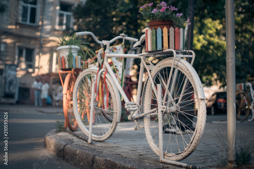 white vintage bicycle in european town;