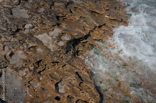 stone texture on the beach with water 