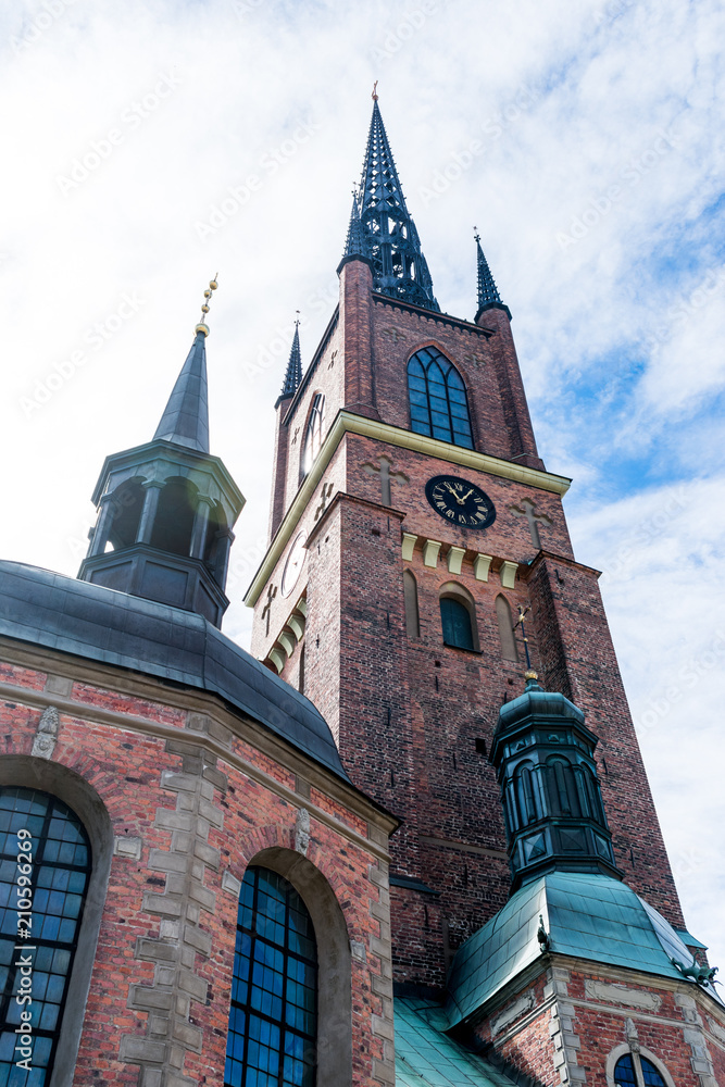 A tall church with blue skies and clouds, in Stockholm, Sweden