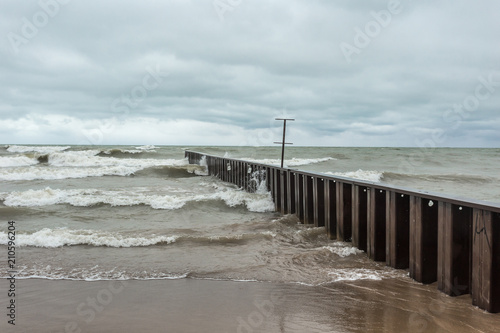 Steel fencing running along beach © Richard