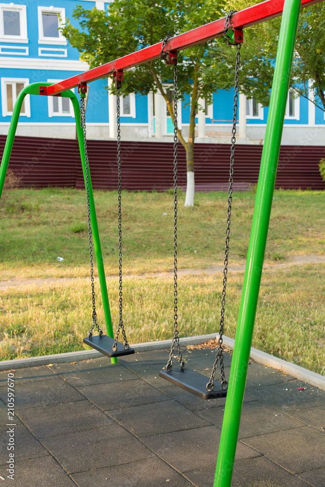 Fototapeta premium Children's entertainment complex, childhood, Child on a swing