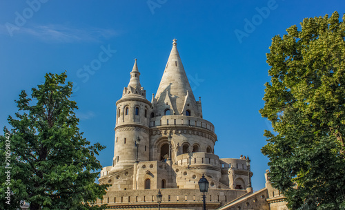 fairy tale white beautiful castle palace facade with towers on blue background in summer time bright colorful day