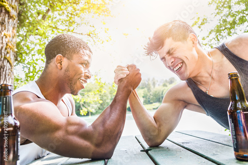 African American Man Arm Wrestling With Mixed Race Man Outdoors photo
