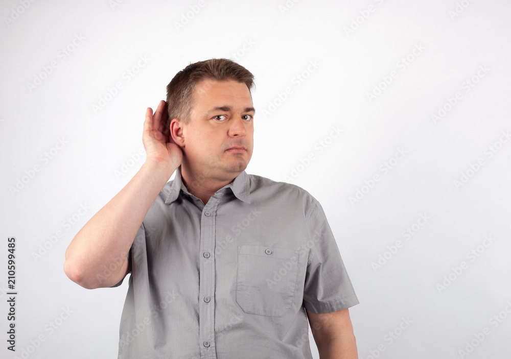 Deaf senior man cupping hand behind ear trying to hear Deaf senior man cupping hand behind ear trying to hear