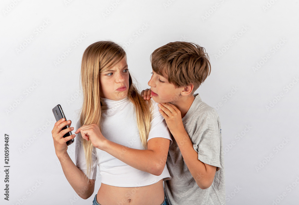 Boy trying to spy a girl's mobile phone but the girl noticed it