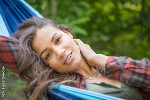 Portrait of Attractive Hispanic Young Adult Girl In Hammock Outdoors