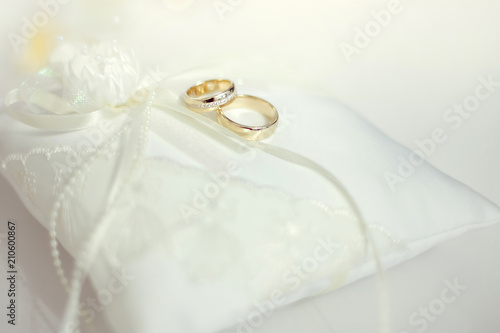 Wedding rings on white lace pillow