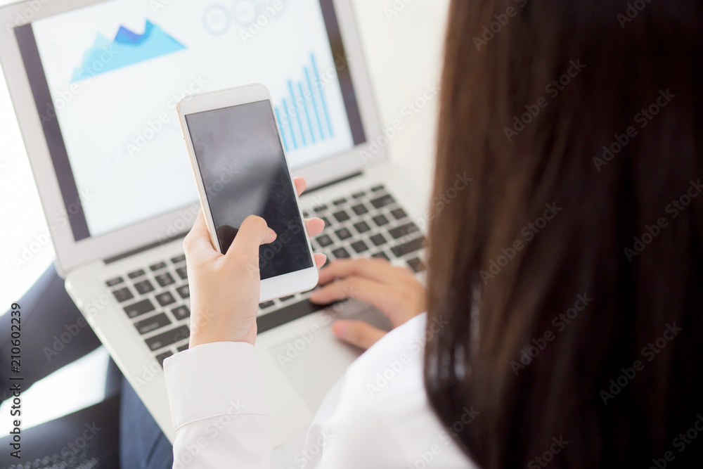 Closeup business woman work with finance analysis and planing data on laptop, girl holding smart mobile phone and typing and looking graph with computer statistic for success, business concept. Closeup business woman work with finance analysis and planing data on laptop, girl holding smart mobile phone and typing and looking graph with computer statistic for success, business concept.