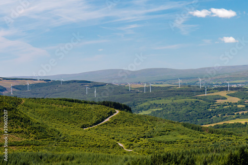 Large wind turbines in a forested rural area of Wales