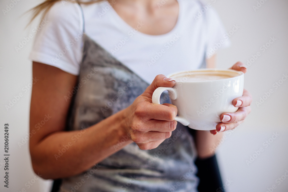 Cup of cappuccino in hand beautiful girl. Cup of cappuccino in hand beautiful girl.