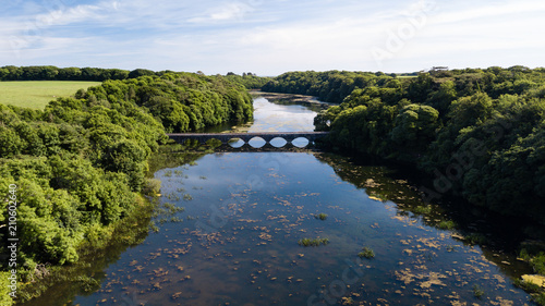 Aerial drone view of an old bridge spanning a beautiful lake in a rural area of Wales