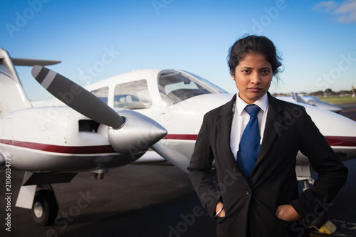 Female Pilot Standing in Front of Her Plane