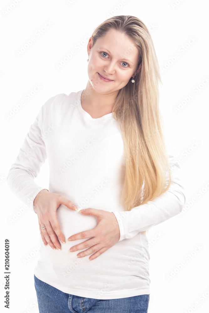 Child-Bearing Ideas and Concepts. Happy Pregnant Caucasian Woman Standing In White Shirt Isolated Against White Background. Child-Bearing Ideas and Concepts. Happy Pregnant Caucasian Woman Standing In White Shirt Isolated Against White Background.