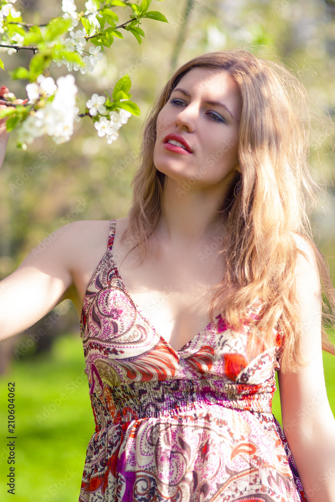 Naklejka premium Portrait of Relaxing Caucasian Blond Female Resting In Park Area in Summer Time.