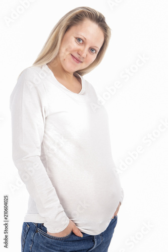 Child-Bearing Ideas and Concepts. Happy Pregnant Caucasian Woman Standing In White Shirt and Jeans Against Pure White Background.