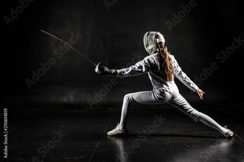 Female fencer isolated on black background