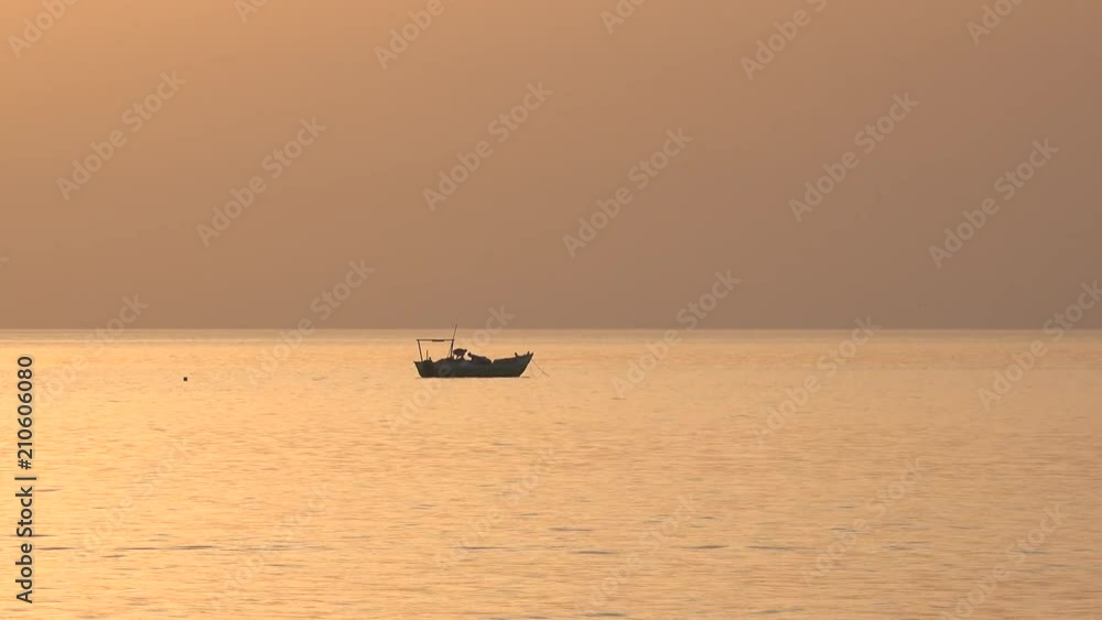 Fishing boat silhouette at tropical sunset - Red Sea, Sudan Fishing boat silhouette at tropical sunset - Red Sea, Sudan