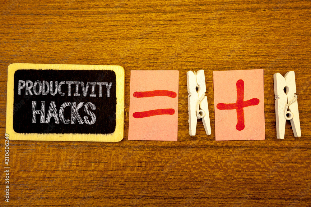 Fototapeta premium Handwriting text Productivity Hacks. Concept meaning Hacking Solution Method Tips Efficiency Productivity White paper clip laid woody desk black slate some texts equal and plus mark.