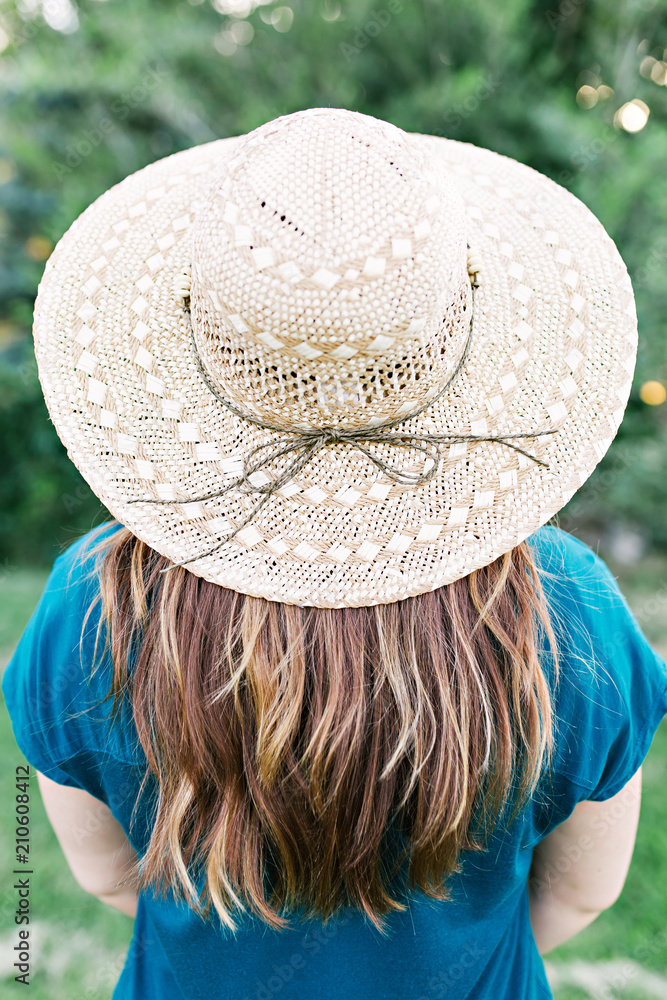 Close up on girl wearing a blue shirt with highlighted red hair wearing a straw  hat with bow Stock Photo | Adobe Stock