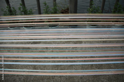 men working on silk with a lake background