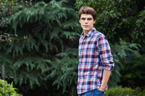 Man in the forest against green tree background