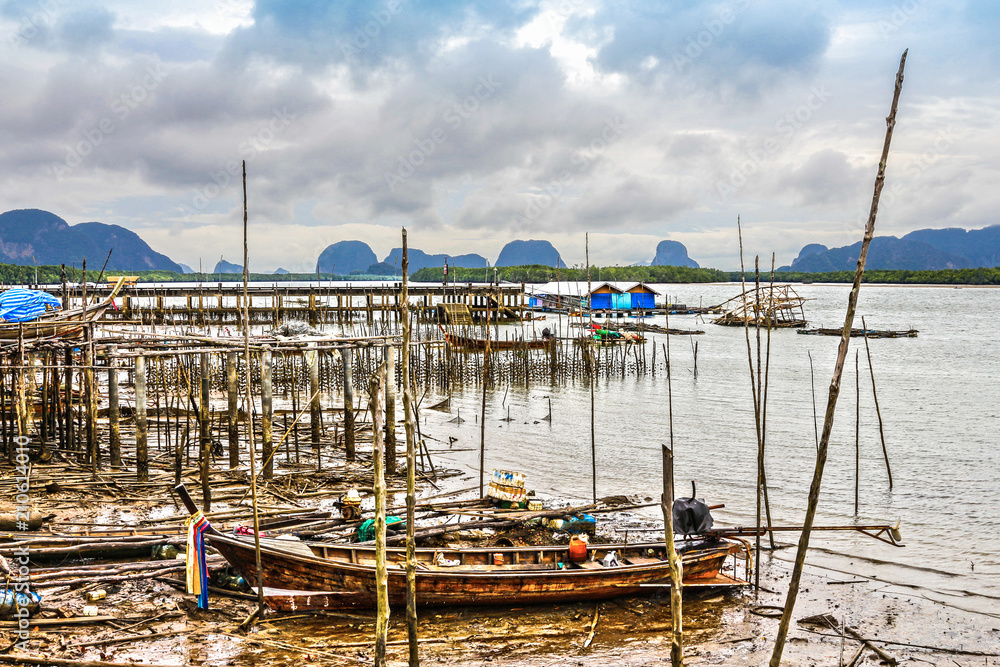 during low tide fishing boats stuck on the mud in Ban Sam Chong fishing village
