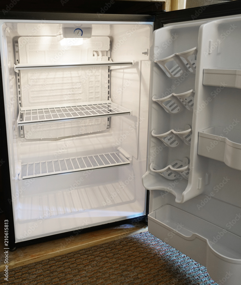 close up on empty refrigerator with door open close up on empty refrigerator with door open